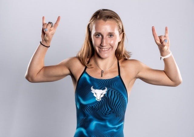 Junior diver Tori Franz strikes a “horns up” pose in a preseason photoshoot.