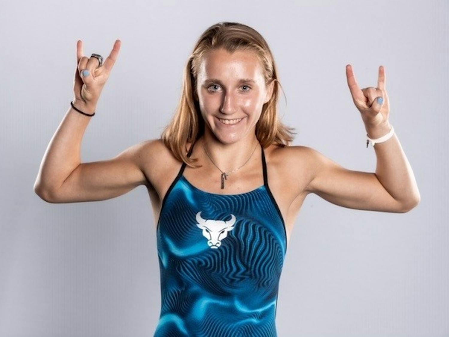 Junior diver Tori Franz strikes a “horns up” pose in a preseason photoshoot.