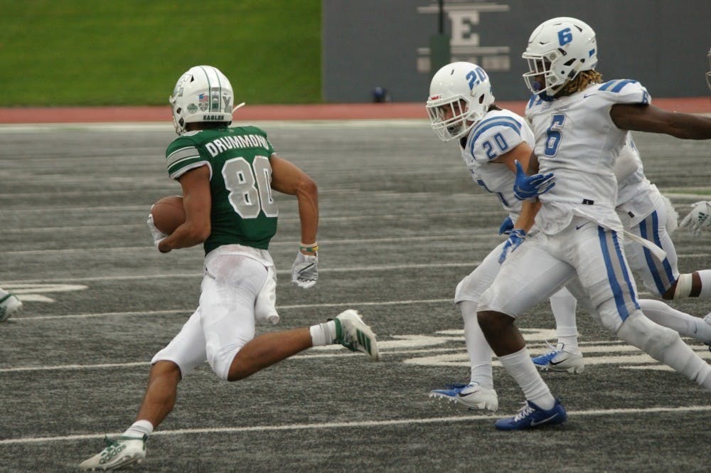 <p>Eastern Michigan wide receiver Dylan Drummond runs into traffic.</p>