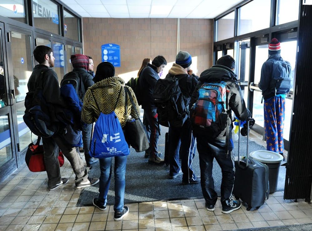 <p>Residents of Red Jacket wait for the shuttle back to their dorm Thursday morning after spending the night in Alumni Arena due to a power outage.</p>