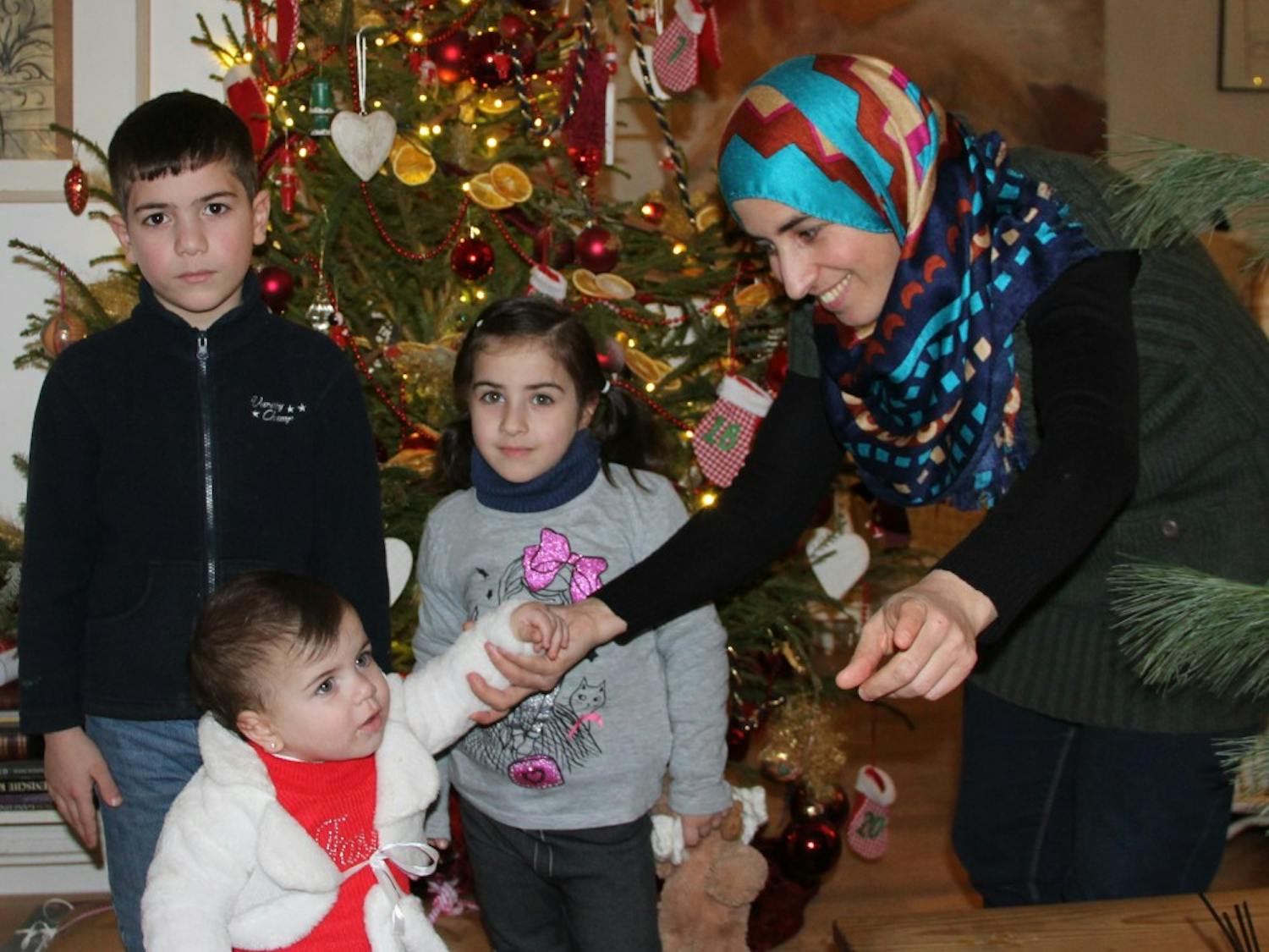 Lubna&nbsp;Albalkhi (right)&nbsp;and her children&nbsp;Mohammed, Bisan and&nbsp;Leen in Berlin&nbsp;around December 2015.&nbsp;The Albalkhi family, including Lubna's husband&nbsp;Sarhan,&nbsp;fled Syria in October.&nbsp;A German woman has helped them with their paperwork and to get jobs and homes in Berlin. She believes if every person helped one family, the refugee crisis would be over.&nbsp;