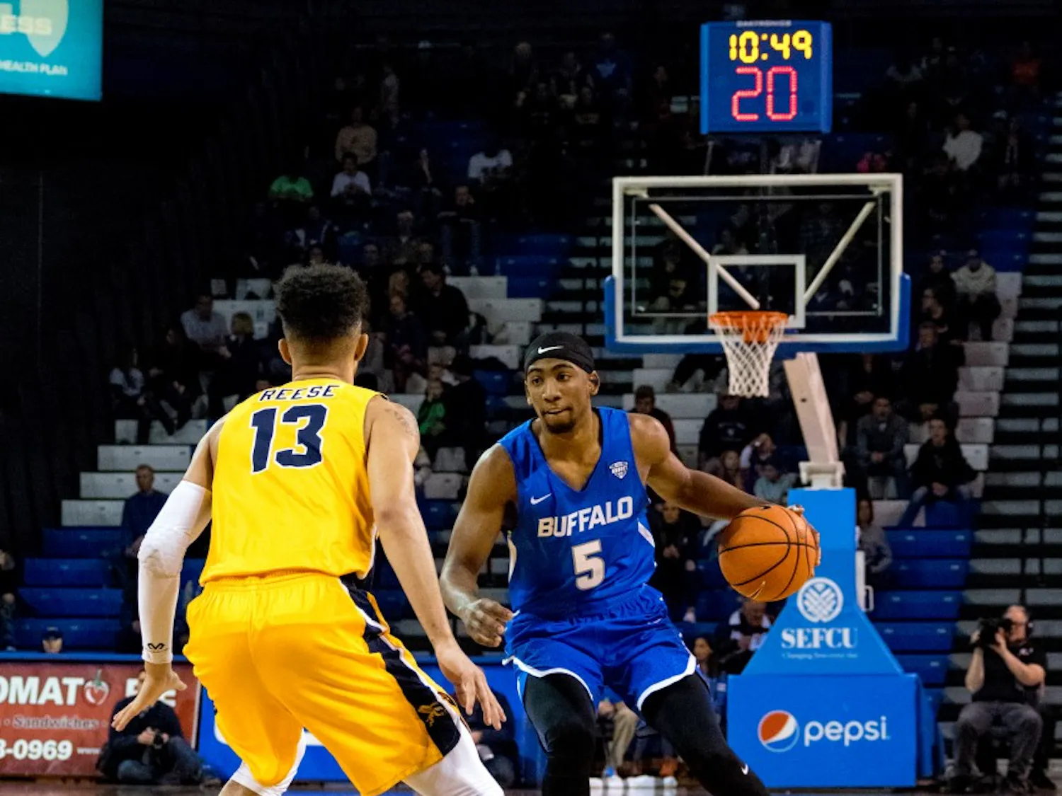 Junior guard CJ Massinburg dribbles the ball at the top of the arc. Massinburg had 8 points, 9 boards and 7 assists in Tuesday's win.