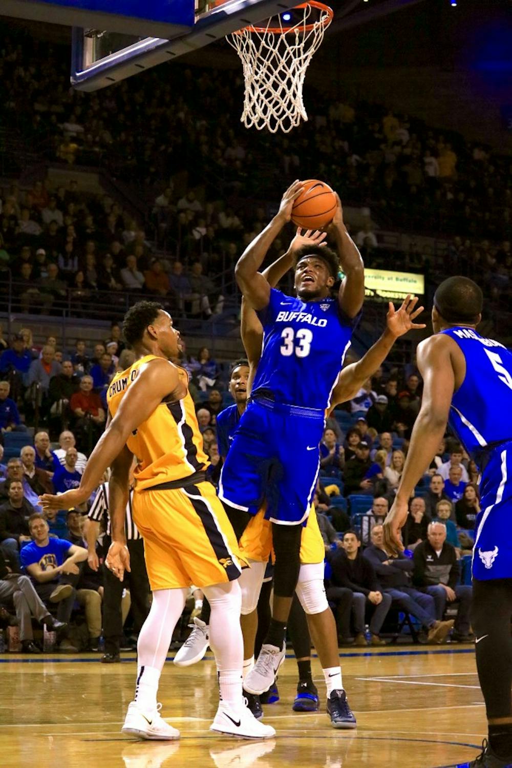<p>Junior forward Nick Perkins fights through contact for a shot. Perkins finished Saturday with a career-high 26 points.</p>
