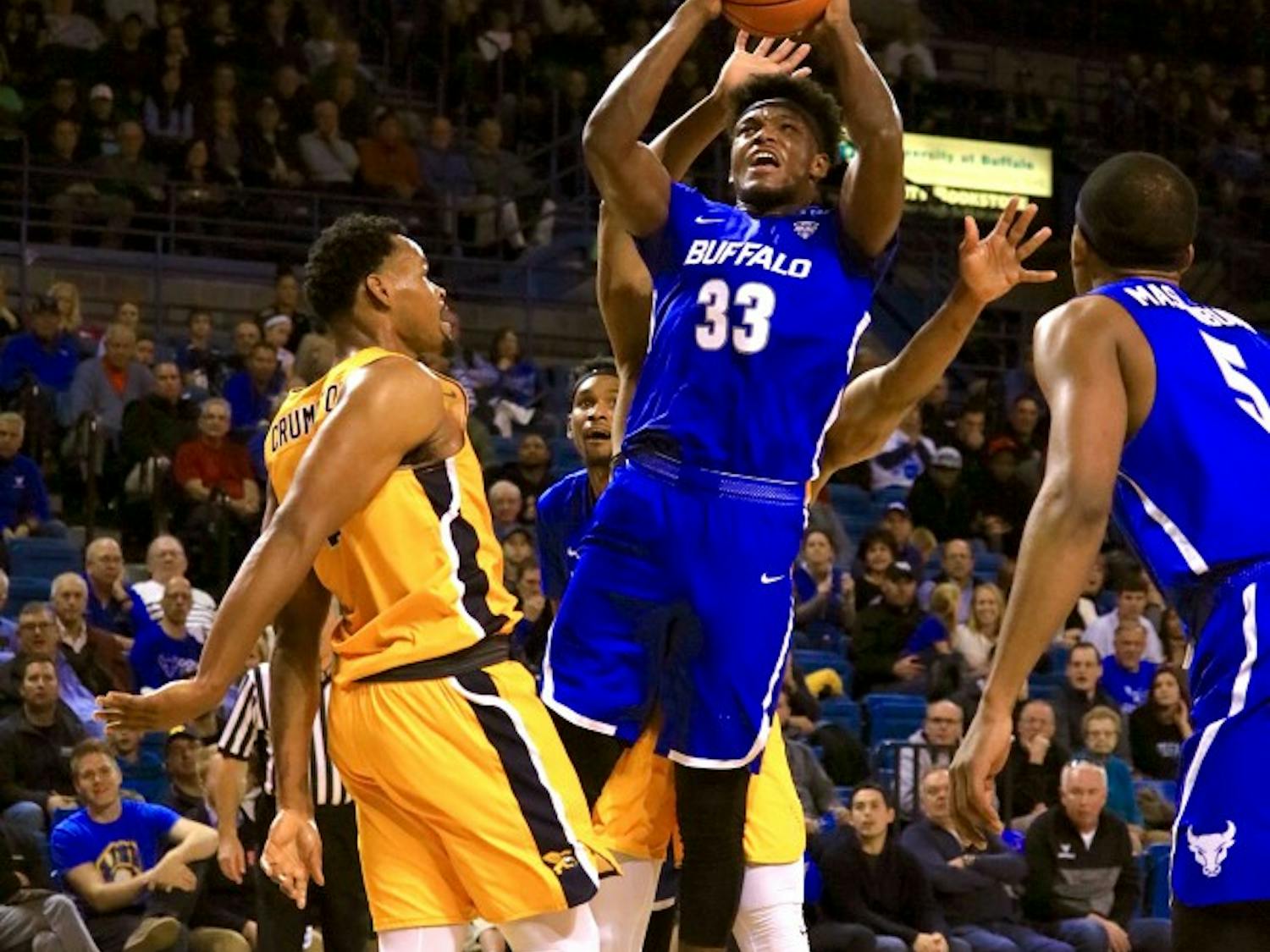 Junior forward Nick Perkins fights through contact for a shot. Perkins finished Saturday with a career-high 26 points.