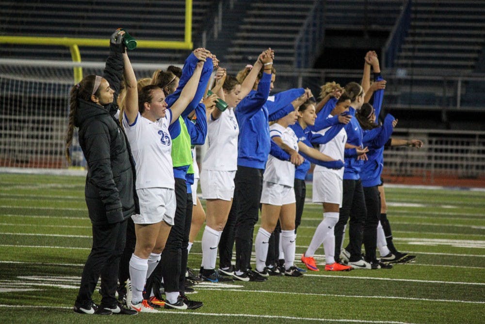 <p>UB women's soccer team hold hands on the UB stadium field&nbsp;after a game.&nbsp;The team looks to close out the rest of the season with three wins so they’re ready for the playoffs.</p>