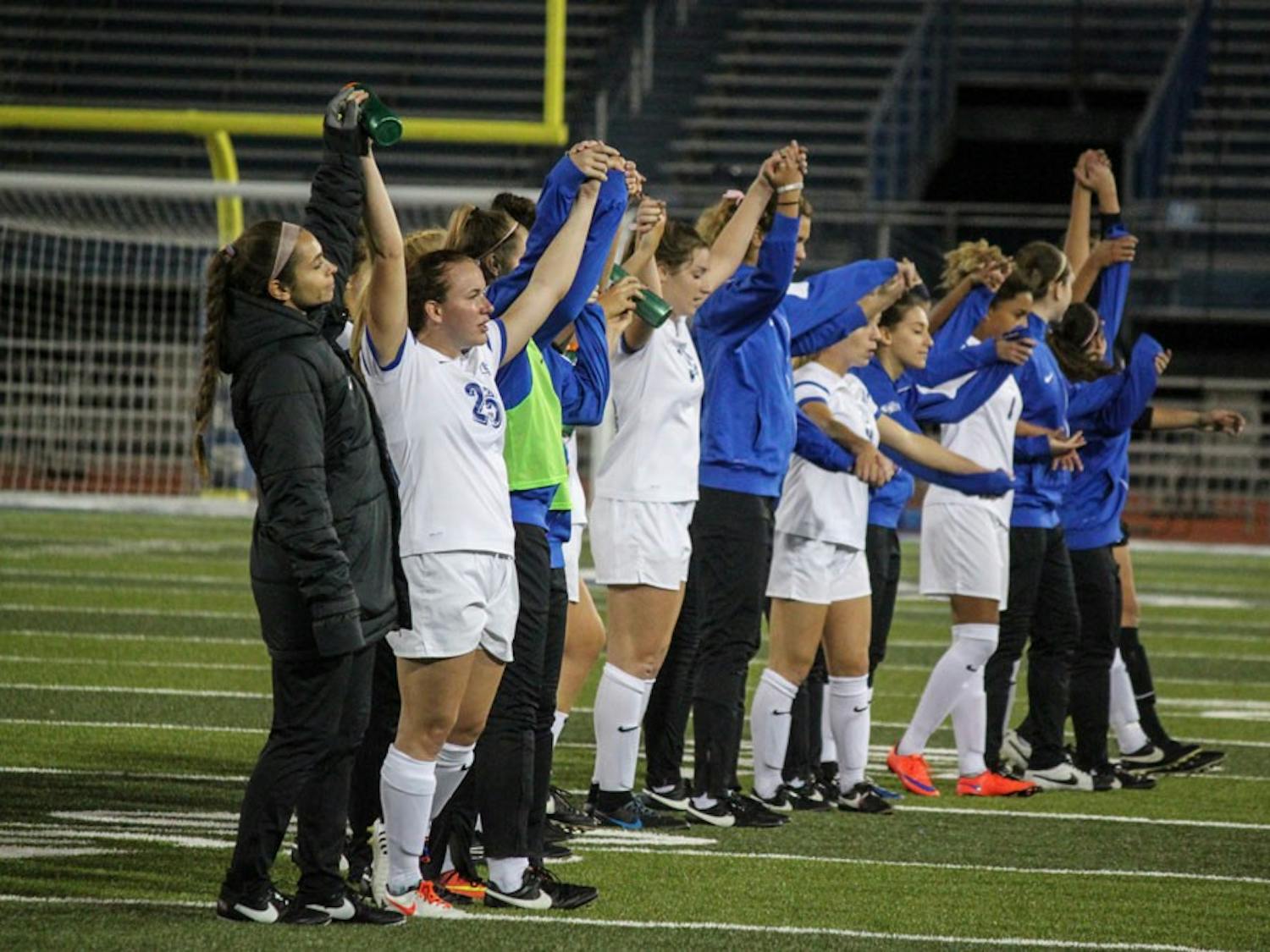 UB women's soccer team hold hands on the UB stadium field&nbsp;after a game.&nbsp;The team looks to close out the rest of the season with three wins so they’re ready for the playoffs.