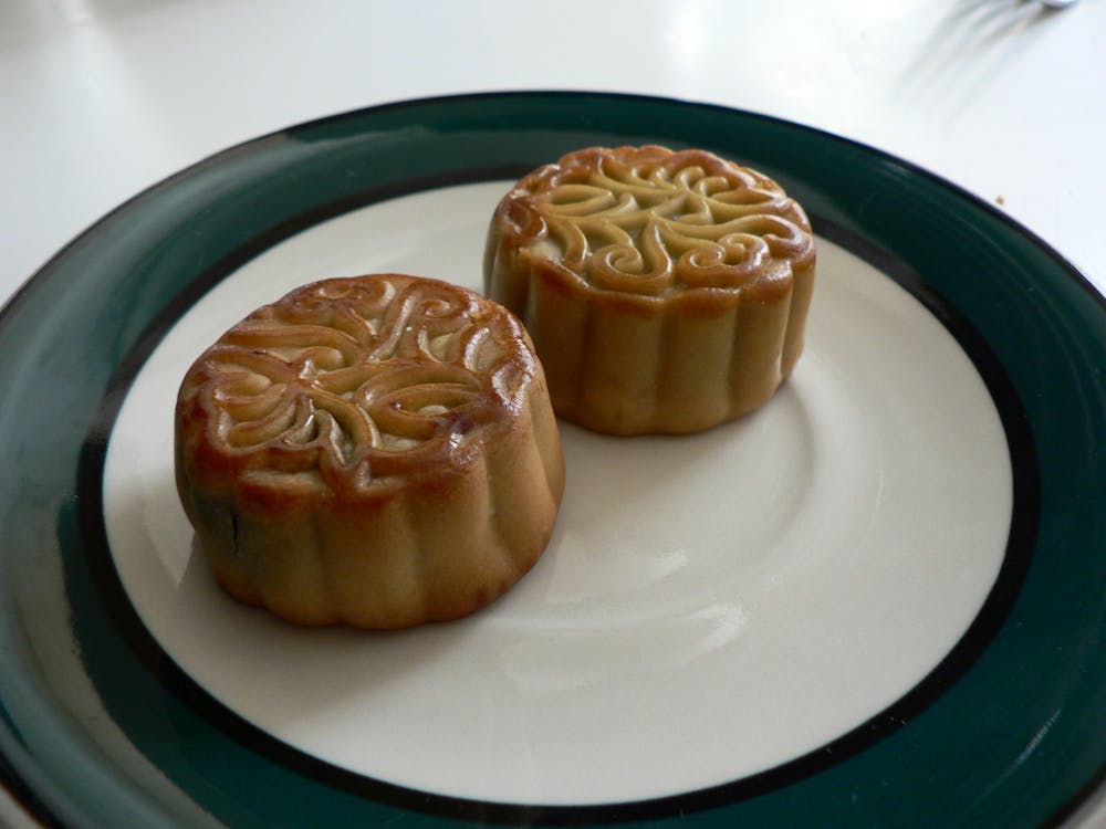 <p>Two mooncakes on a plate.</p>
