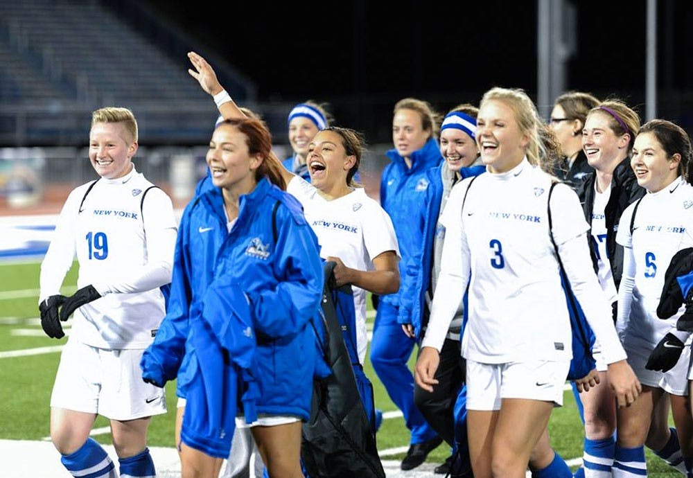 <p>Members of the 2015-16 UB women's soccer team celebrate after a matchup in the MAC Tournament. Kay players will not return next year, but a solid spring season leaves Shawn Burke relaxed about replacing them.&nbsp;</p>