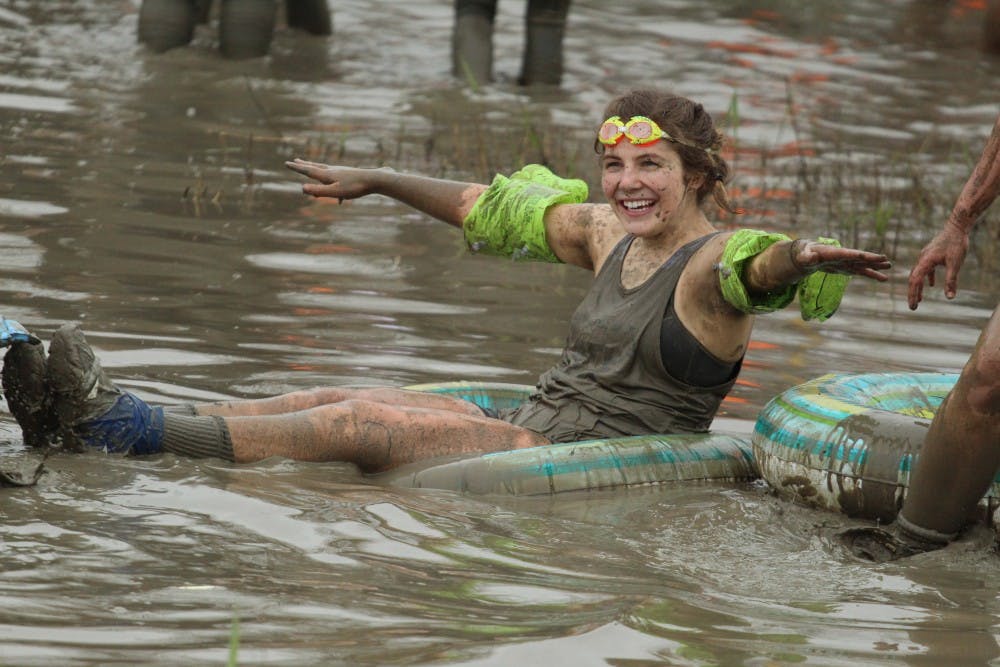 UB student uses an inflatable tube in the "mud pool." Eliminated team members found ways to continue to enjoy the pit after their matches.
