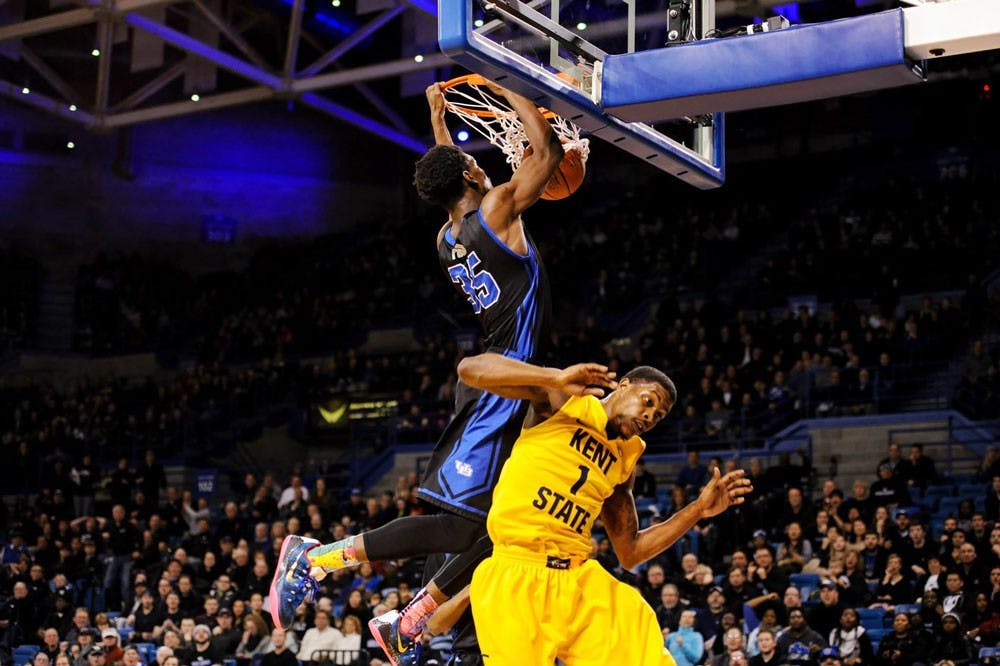 <p>Xavier Ford scores a basket over Kent State’s Kris Brewer. The Bulls won both games this past week and are currently riding a four-game winning streak leading into the final two games of the season.</p>