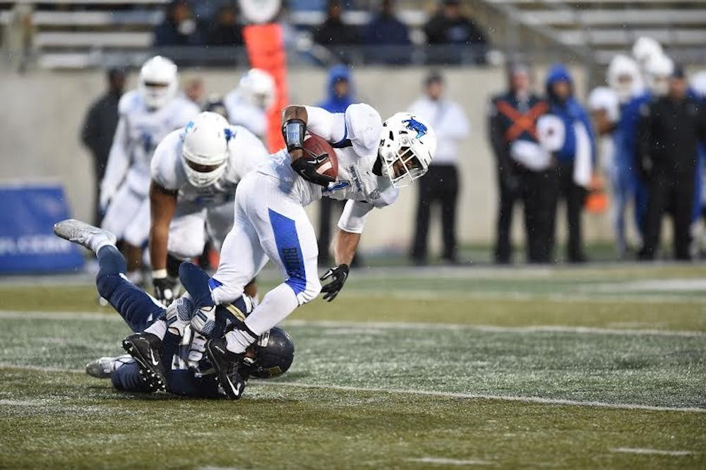 <p>Senior running back Anthone Taylor gets tripped up by an Akron defender in Buffalo's 42-21 loss Saturday. The Bulls will head into their season finale against Massachusetts next week needing a win for any chance at a bowl game.&nbsp;</p>