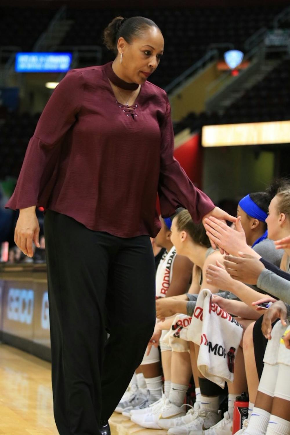 <p>Felisha Legette-Jack high fives her players at the bench. Legette-Jack believes her team has the depth for another successful season.</p>