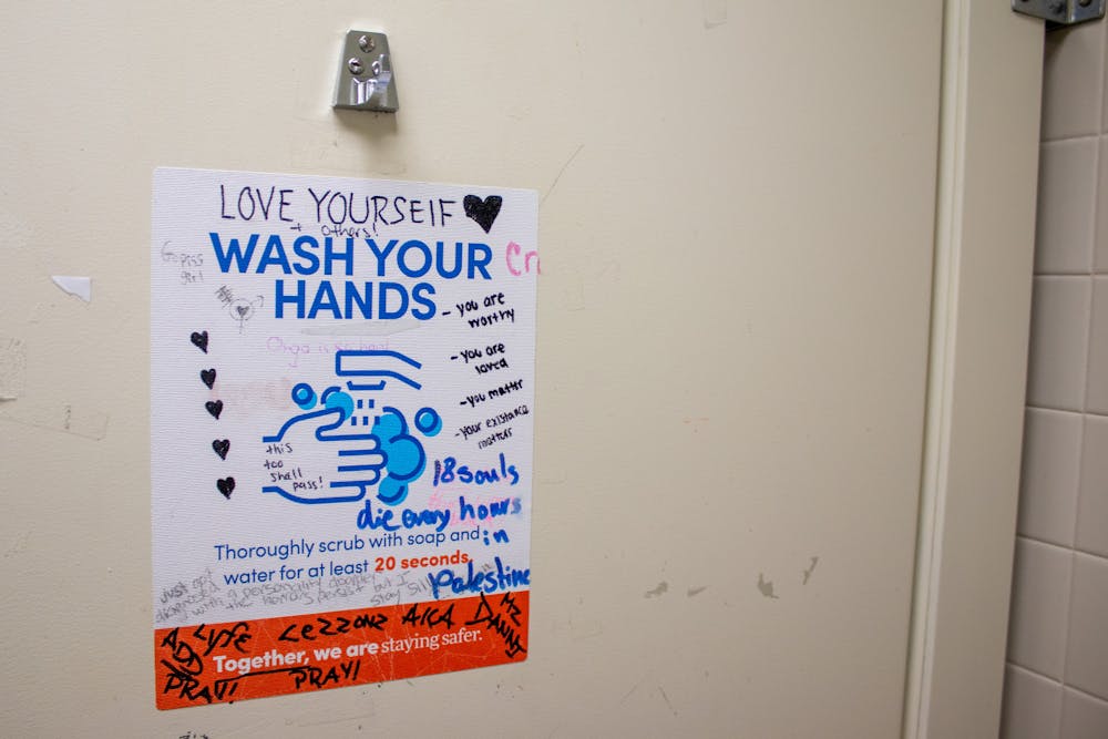 <p>Graffiti peppers the walls of bathrooms of UB's campus.</p>