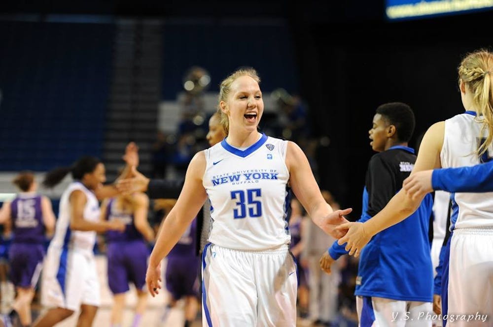 <p>Junior guard Mackenzie Loesing celebrates&nbsp;with teammates after a win.&nbsp;</p>