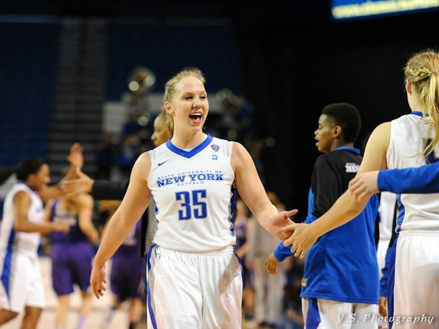 Junior guard Mackenzie Loesing celebrates with teammates after a win. 