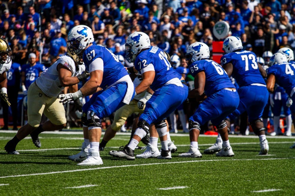 <p>UB football’s offensive line protects against the rush in a previous game. The line opened up huge holes for freshmen running backs Kevin Marks and Jaret Patterson to each eclipse 100 yards against Central Michigan.</p>
