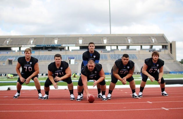 Quarterback Joe Licata lines up behind his starting offensive line. Left to right: John Kling, Robert Blodgett, Trevor Sales, Andre Davis and Jake Silas. Buffalo returns all five offensive linemen from its 2013 bowl season.&nbsp;Aline Kobayashi, The Spectrum