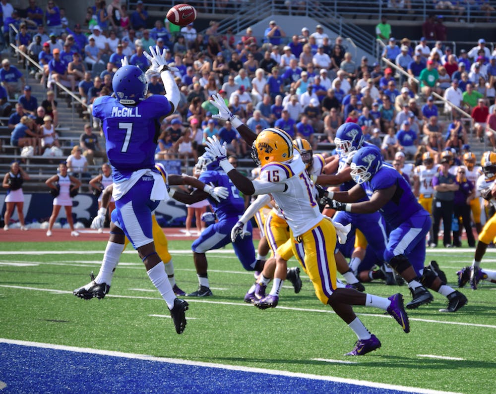 <p>Senior wide receiver Marcus McGill (7) catches the Bulls' first touchdown of the game and season on a 9-yard pass from senior quarterback Joe Licata. </p>
