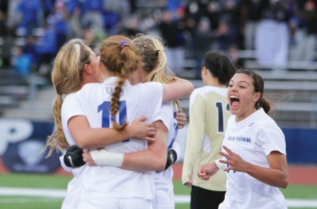 The women’s soccer team celebrates junior defedner jackie Hall’s game-winning goal in the MAC Championship game. 