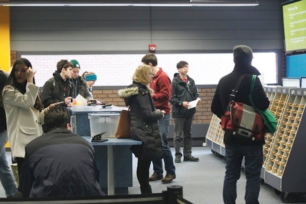 Students wait for their printouts in Lockwood Library. Many students
havereported experiencing longer print turnaround times than
usual this semester. Elaine Lam, The Spectrum&nbsp;