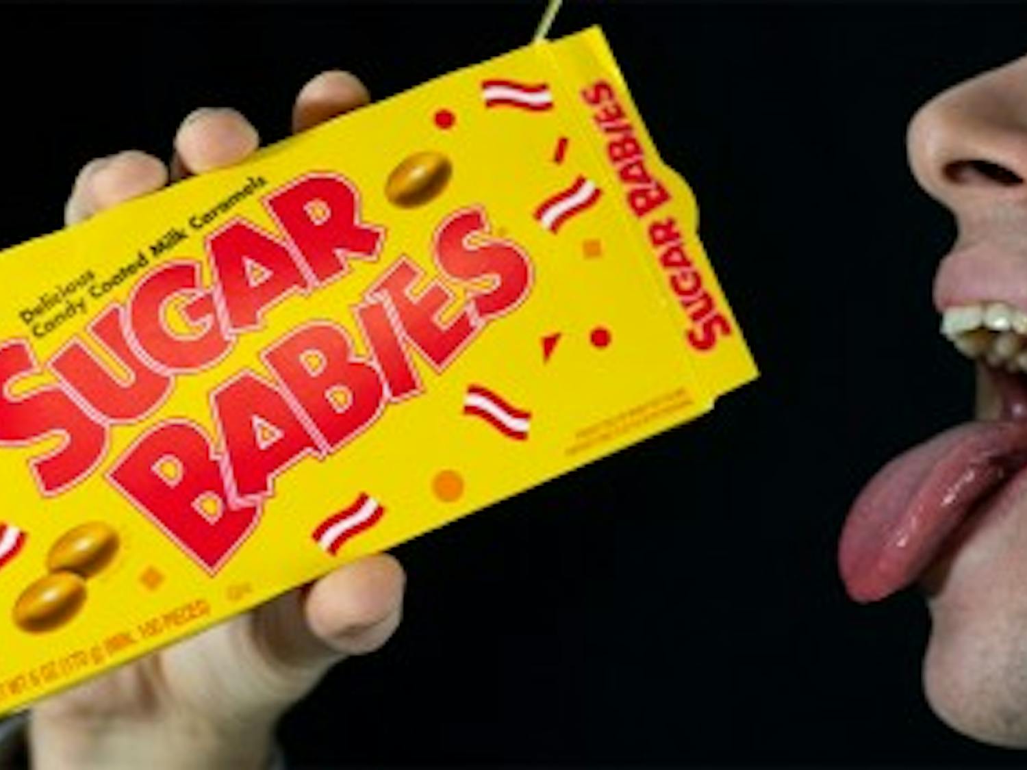 Photo Illustration of students eating Sugar Babies caramels. UB students are finding life as a sugar baby as an alluring cash-making alternative.