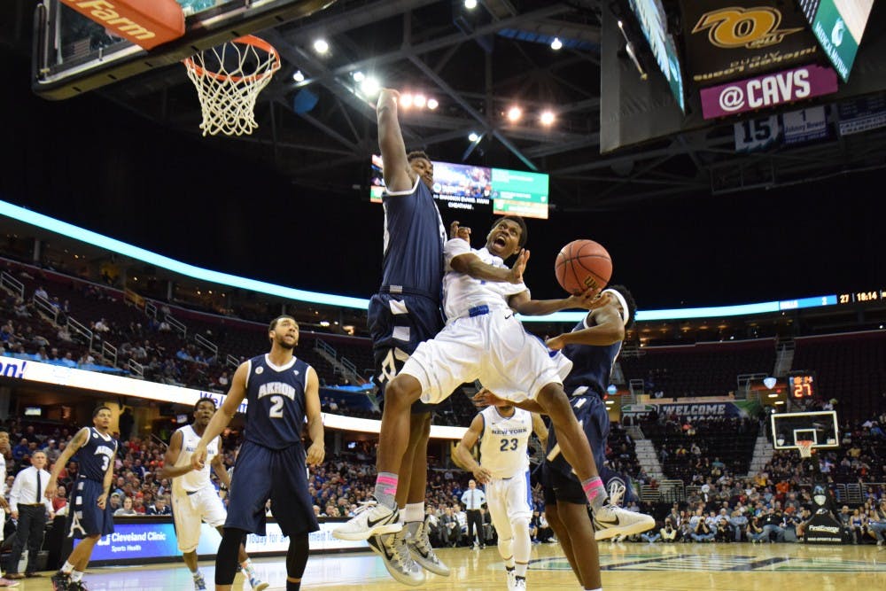 <p>Freshman guard Lamonte Bearden goes up to shoot against an Akron defender. Bearden scored 10 points in Friday night's victory over Akron. The Bulls will face Central Michigan on Saturday night for the MAC title. </p>