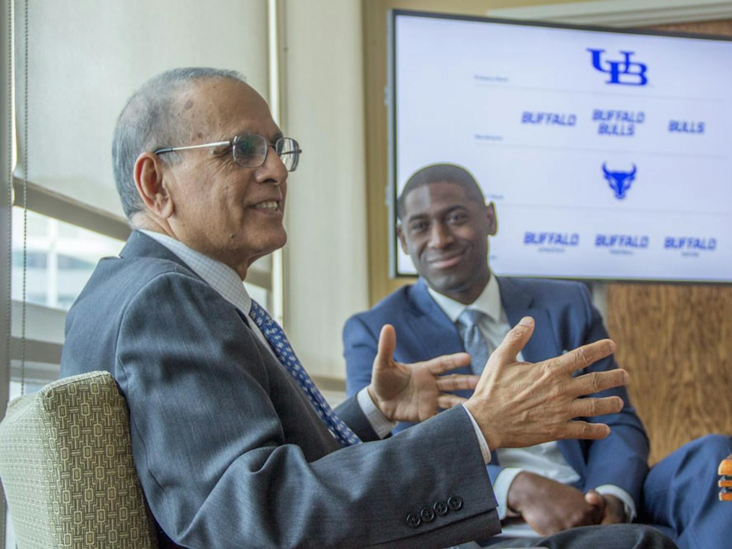 Satish Tripathi (front), UB president and Allen Greene, UB Athletic Director (back) discuss UB’s recently launched branding initiative, which looks to unite all of UB’s schools and units around the “University at Buffalo” name.