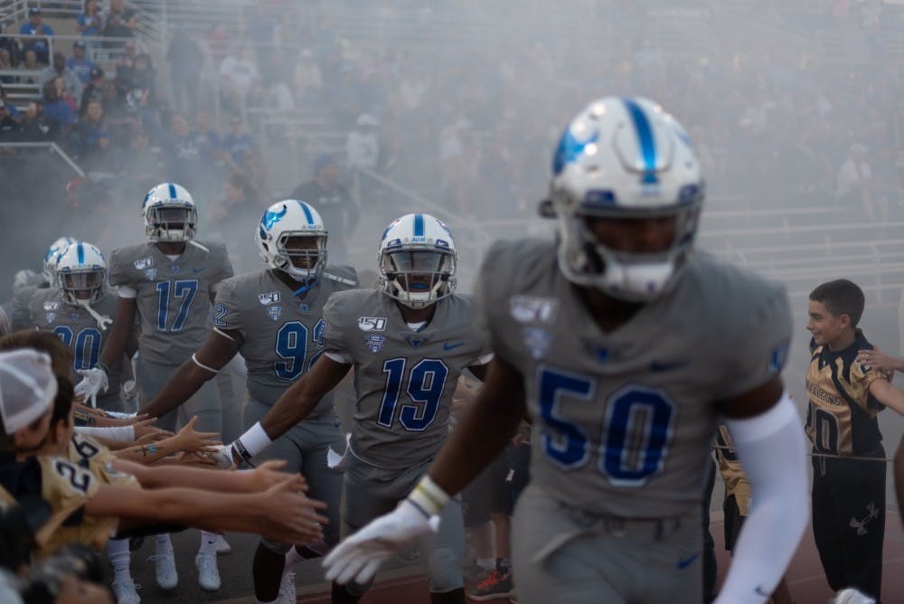 The Bulls storm UB Stadium during an early game this season.