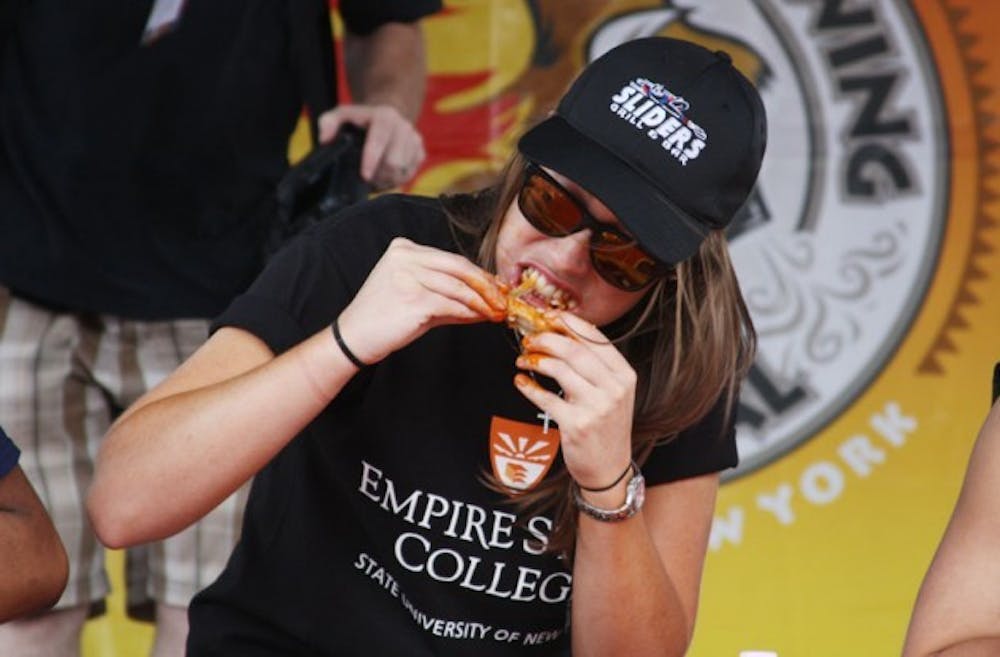 Lauren Joyce (pictured) represented Empire State College as one of 8 competitors in Sunday&rsquo;s college wing eating competition. Representatives from UB, Medaille, RIT, Northwestern, Buffalo State College and Canisius had eight minutes to eat 25 wings from Sliders Bar &amp; Grill. The winner, who represented Medaille finished all 25 wings in five minutes 45 seconds and was the only one to finish all 25 wings. ?Jordan Oscar, The Spectrum