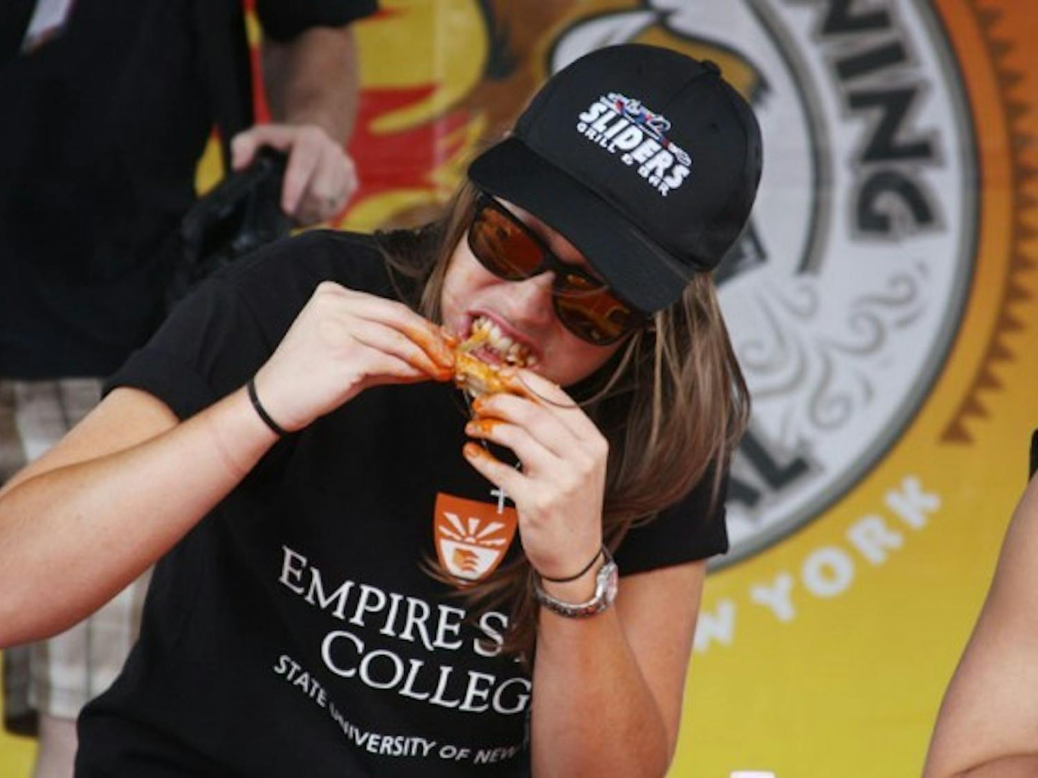 Lauren Joyce (pictured) represented Empire State College as one of 8 competitors in Sunday&rsquo;s college wing eating competition. Representatives from UB, Medaille, RIT, Northwestern, Buffalo State College and Canisius had eight minutes to eat 25 wings from Sliders Bar &amp; Grill. The winner, who represented Medaille finished all 25 wings in five minutes 45 seconds and was the only one to finish all 25 wings. ?Jordan Oscar, The Spectrum