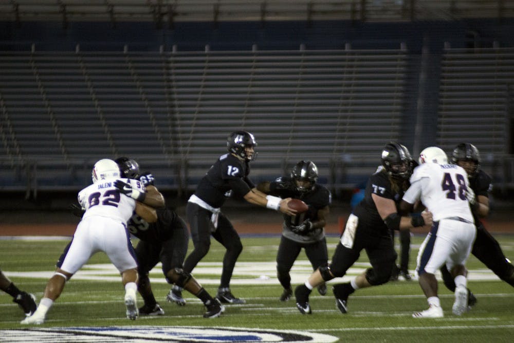 <p>Junior quarterback Drew Anderson hands the ball off to redshirt sophomore running back&nbsp;Emmanuel Reed. Anderson came in after the injury of&nbsp;redshirt sophomore quarterback Tyree Jackson.</p>