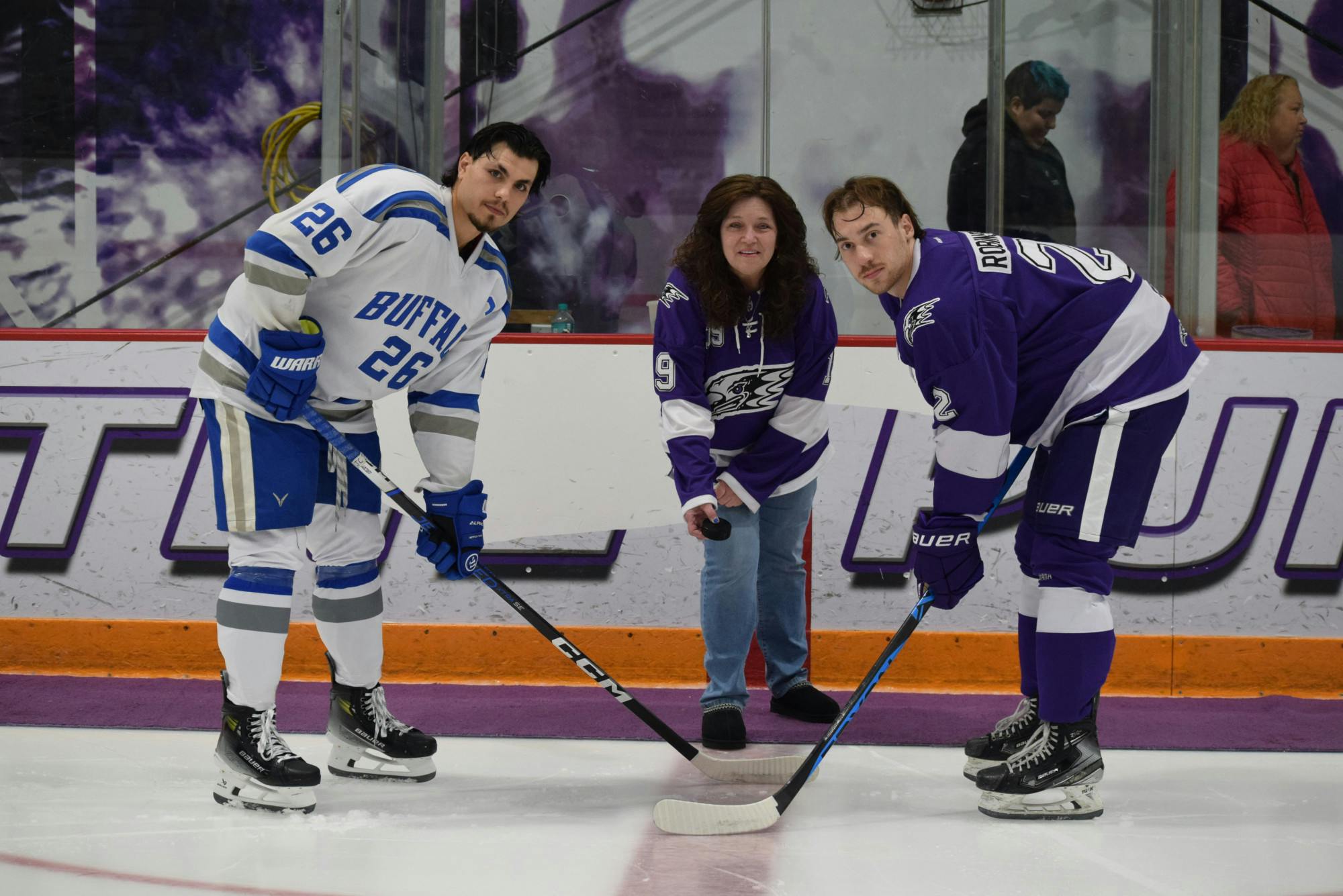 Ceremonial puck drop prior to the 2023 "Midnight Madness" game between UB and Niagara. Left to right: UB captain Anthony Coty, Charlene Romano, Niagara captain Austin Robinson. | Courtesy of Madyson Lakatos