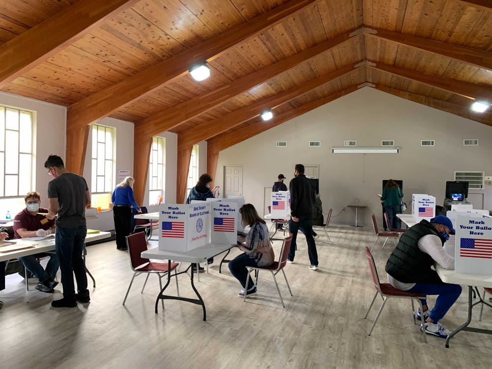 <p>People vote in Amherst Baptist Church on Election Day</p>