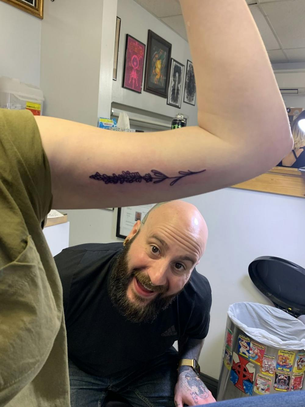 <p>Tattoo artist Marc Lavey admires his flash tattoo on UB alumni Rachel Robert at CowPok Piercing and Tattoos’ annual fundraiser.</p>