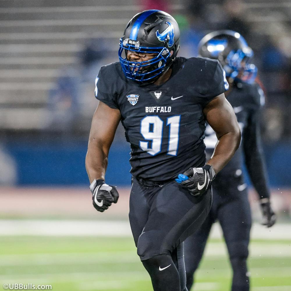 <p>Former UB football defensive end Demone Harris celebrates after making a play.</p>