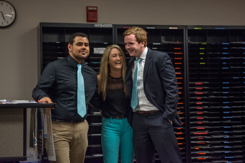 <p>(From left to right) Matt Rivera, Megan Glander and Dan Emmons celebrate their Student Association elections victory moments after the announcement in the SA office Thursday.&nbsp;The Progress Party candidates will assume their SA executive board positions at the end of the semester.&nbsp;</p>