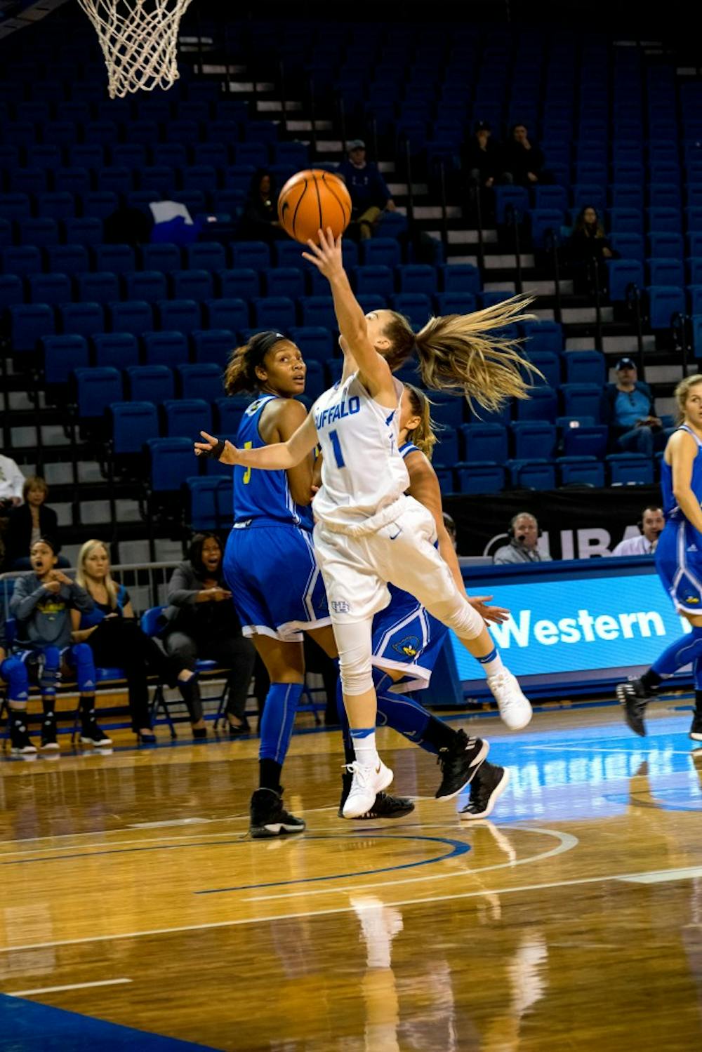 <p>Senior guard Stephanie Reid comes in for the layup. Reid is coming off a strong performance in the Bulls' win on Saturday.</p>