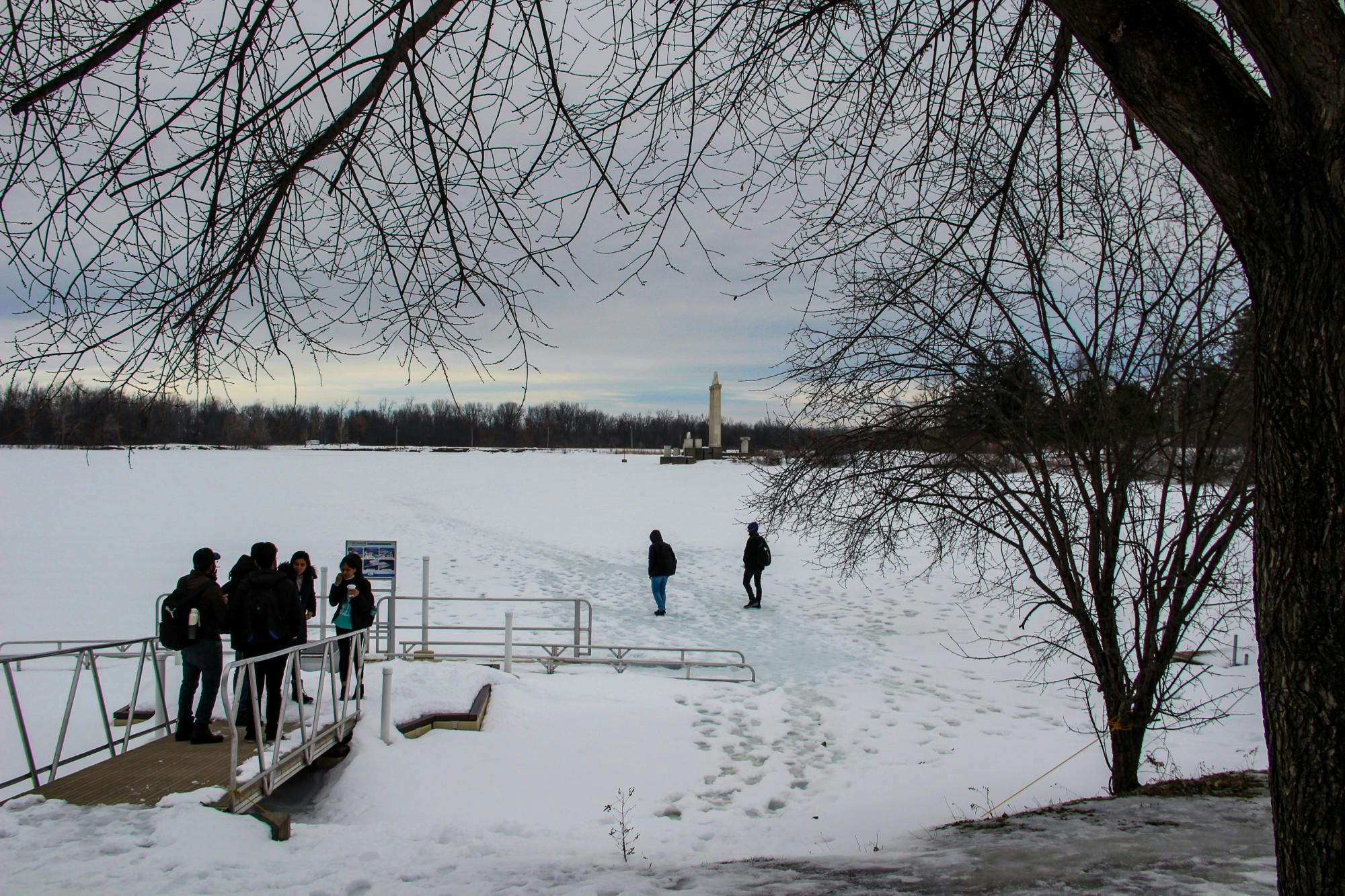 Students walk on a frozen Lake LaSalle during the 2022 spring semester.&nbsp;
