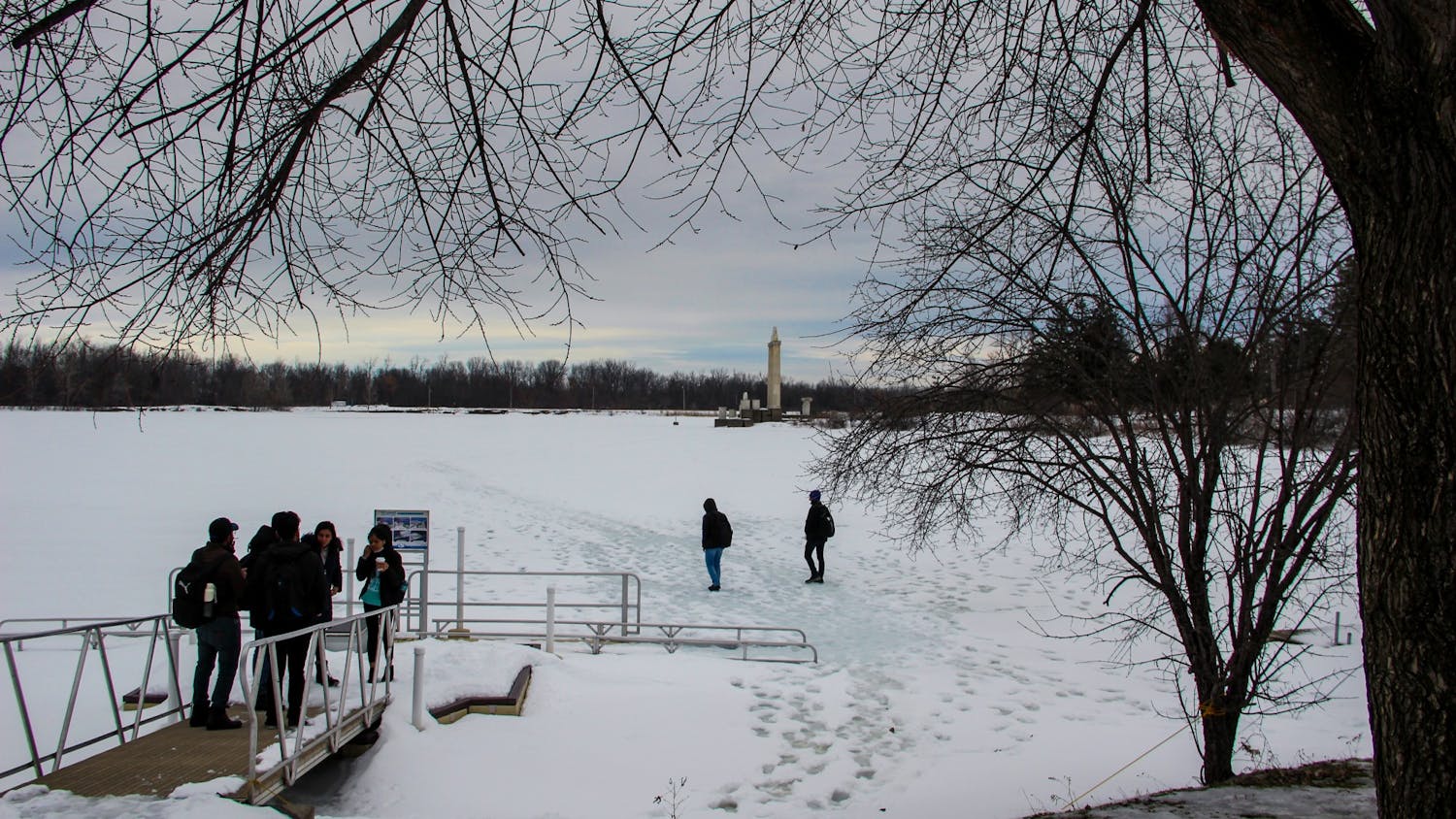 Students walk on a frozen Lake LaSalle during the 2022 spring semester.&nbsp;
