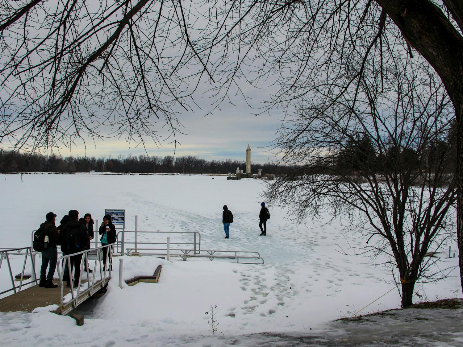 Students walk on a frozen Lake LaSalle during the 2022 spring semester.&nbsp;