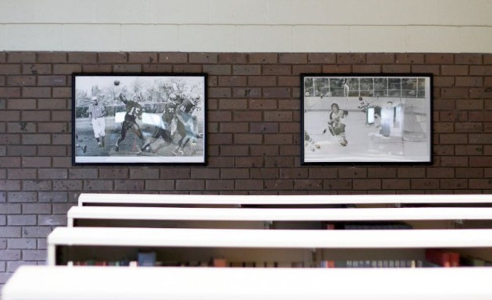 Historical photos and posters hang above the stacks in Lockwood Memorial Library and in the Oscar A. Silverman Library and while many students may not notice them during study sessions, the prints are available for sale online through the Library Store.&nbsp;Derek Drocy, The Spectrum