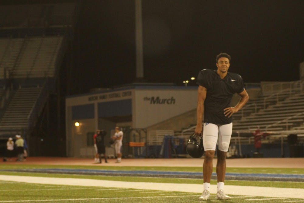 <p>UB football player Dominic Johnson stands on UB Stadium.</p>