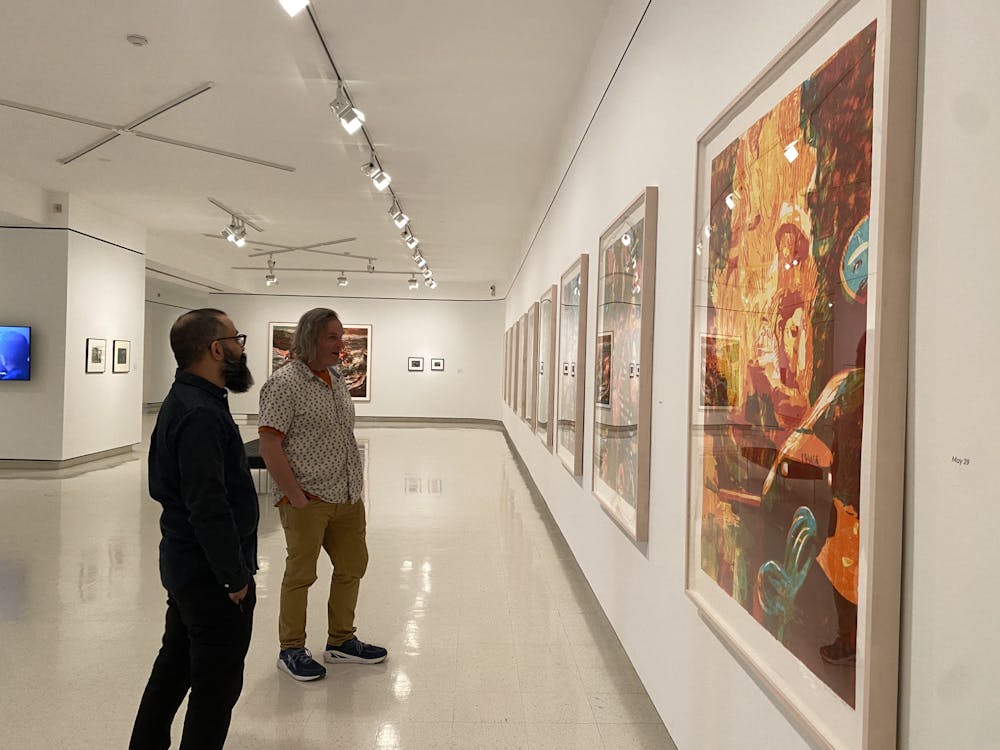 <p>Artists Zorawar Sidhu and Rob Swainston stand in front their work at the “History is Present" exhibition. The exhibit will be on view at UB’s Anderson Gallery until July 26.&nbsp;</p>