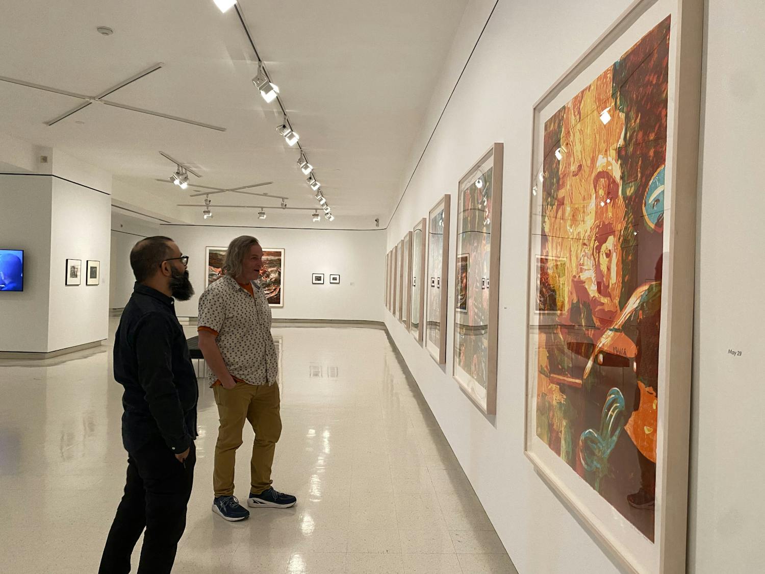 Artists Zorawar Sidhu and Rob Swainston stand in front their work at the “History is Present" exhibition. The exhibit will be on view at UB’s Anderson Gallery until July 26. 