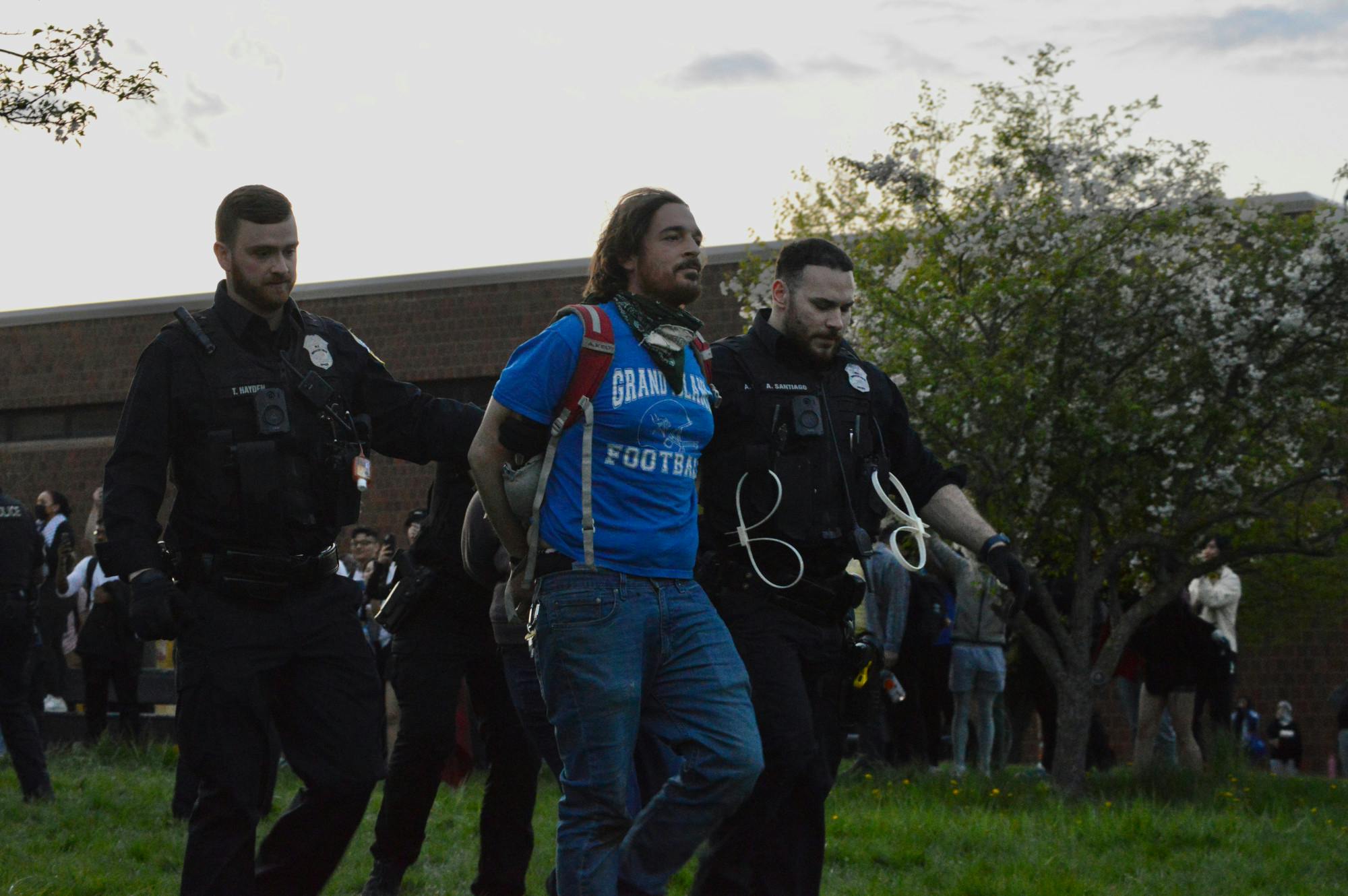Two Buffalo police officers arrest a protester Wednesday, May 1, 2024, on UB's North Campus.&nbsp;