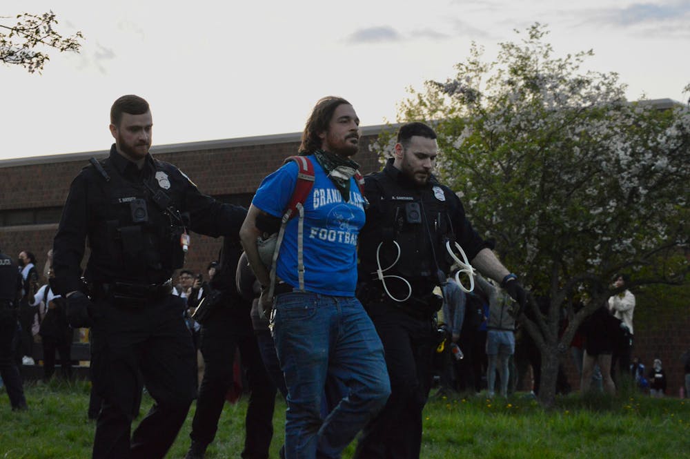<p>Two Buffalo police officers arrest a protester Wednesday, May 1, 2024, on UB's North Campus.&nbsp;</p>