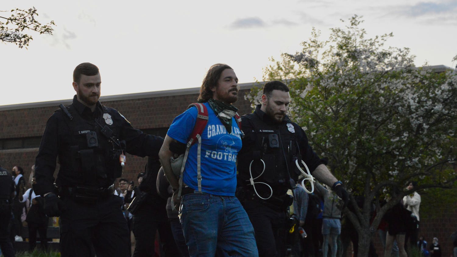 Two Buffalo police officers arrest a protester Wednesday, May 1, 2024, on UB's North Campus.&nbsp;