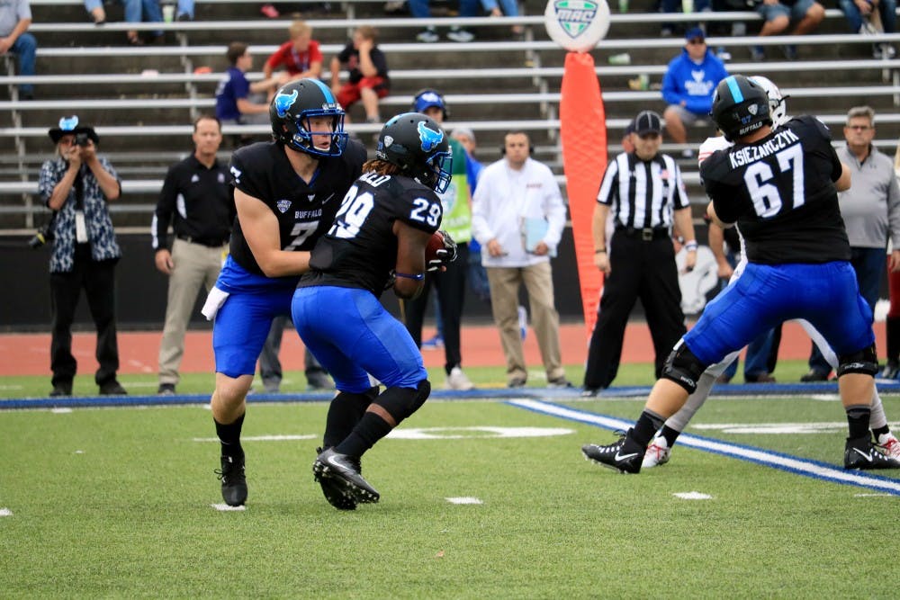 <p>Freshman quarterback Kyle Vantrease hands the ball off to redshirt sophomore running back Emmanuel Reed. Reed finished the game with 56 yards on 13 carries.&nbsp;</p>