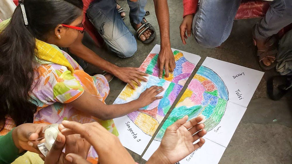<p>Students at Calcutta Rescue work together on a project for Beyond the Block. Calcutta Rescue is a non-government organization specialized in helping and educating children from nearby slums.</p>