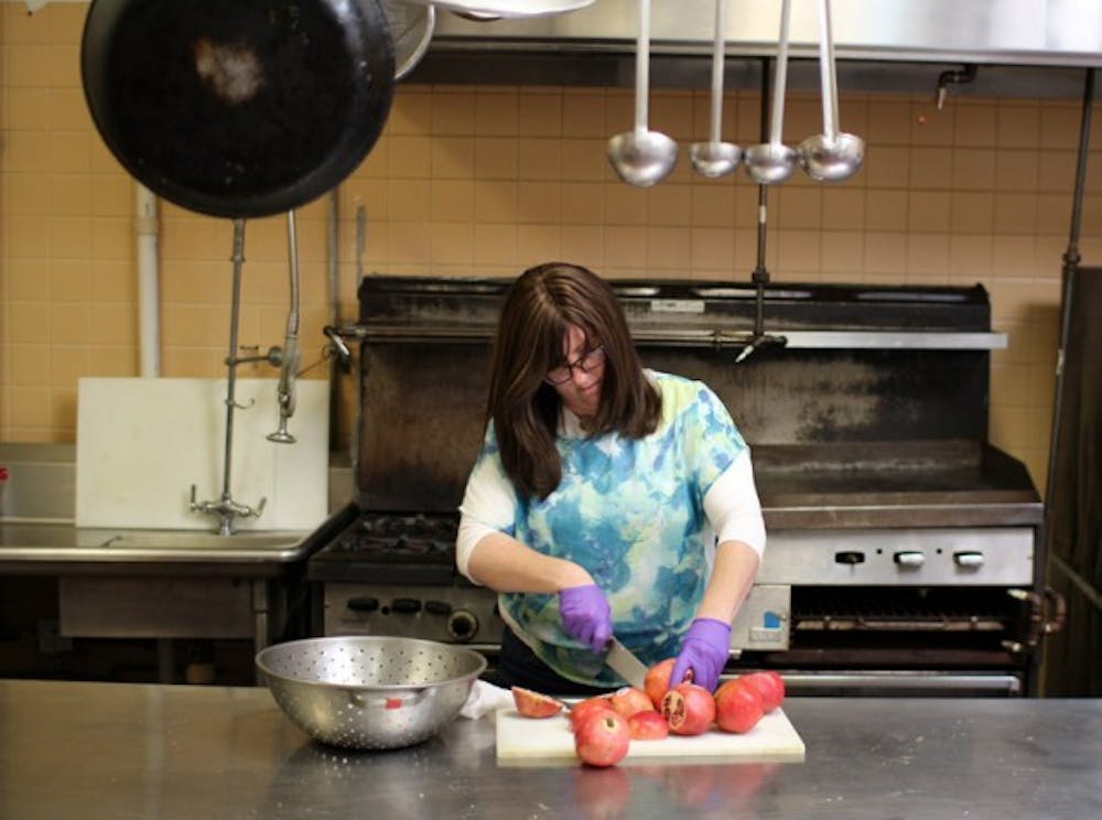 Rivka Gurary, wife of Rabbi Moshe Gurary of the Chabad House Jewish Center, prepares Rosh Hashanah dinner for over 300 expected guests for Wednesday&rsquo;s dinner.&nbsp;Yusong Shi, The Spectrum